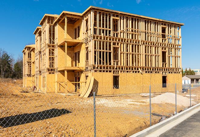 a close-up of temporary chain link fences enclosing a construction site, signaling progress in the project's development in Ostrander